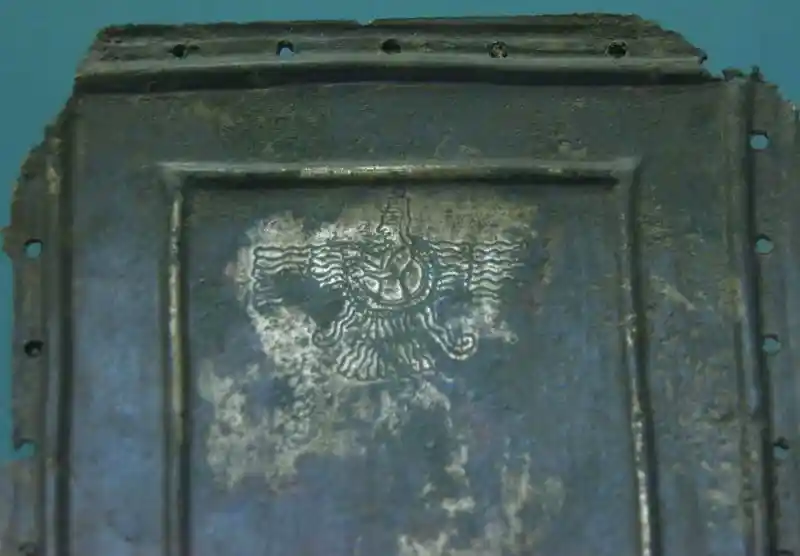 Winged disc with a god in the middle on a bronze plaque from a horse harness